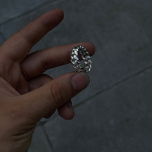 Load image into Gallery viewer, A hand holding a silver Cuban link ring with a polished finish.
