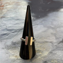 Load image into Gallery viewer, A handmade sterling silver T-Bar ring displayed on a textured surface.